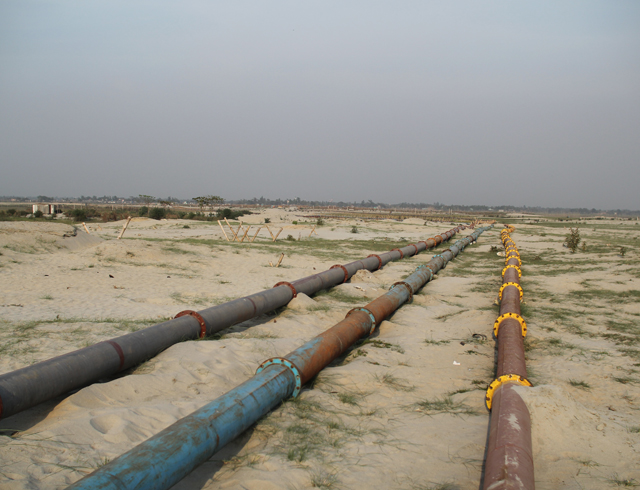 Development practices include sandfilling, a process that erases the deltaic ecology and alters the natural hydrology. In this photo, sand pipelines stretch across the land.