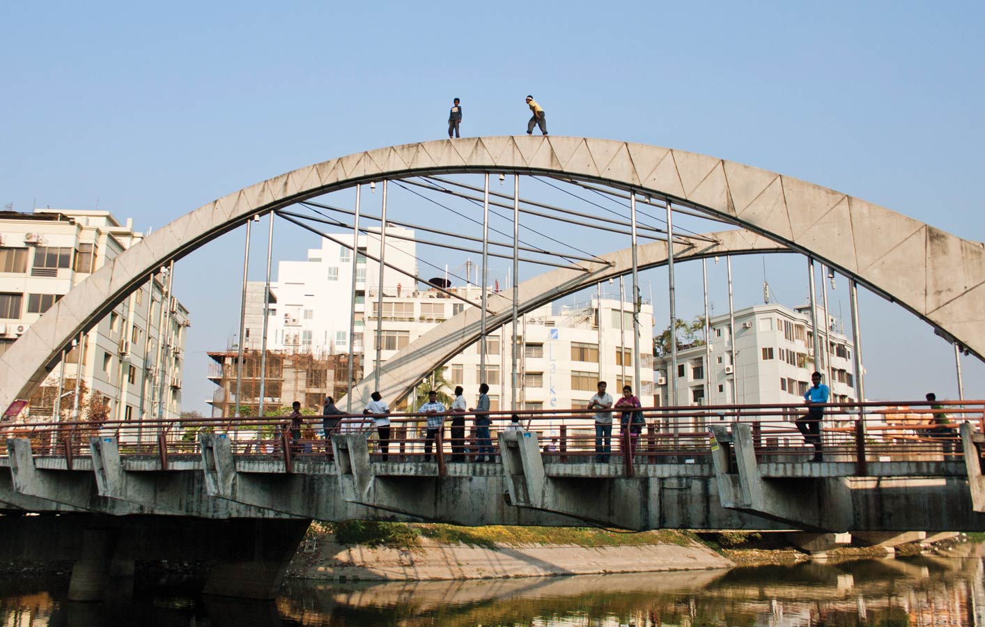 <p>Boys climb atop Banani Bridge near Korail slum.</p>