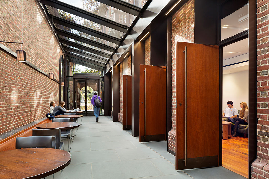 <p>A light court transformed a dark alleyway between a residential hall and dining hall. It is now an active common space in its own right, providing flexible connections among dining hall, seminar rooms, lounge space, and games area. &nbsp;<br />&copy; Michael Moran / OTTO</p>