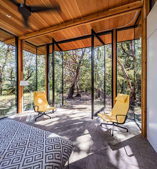 <p>Rooms were designed to be defined by their natural boundaries, such as tree lines and views, instead of by their walls and windows. <br><small>&copy;Tim Griffith</small></p>